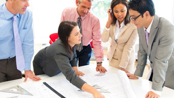 Engineers Converse Over Blueprints - Blueprint and mechanical drawing training